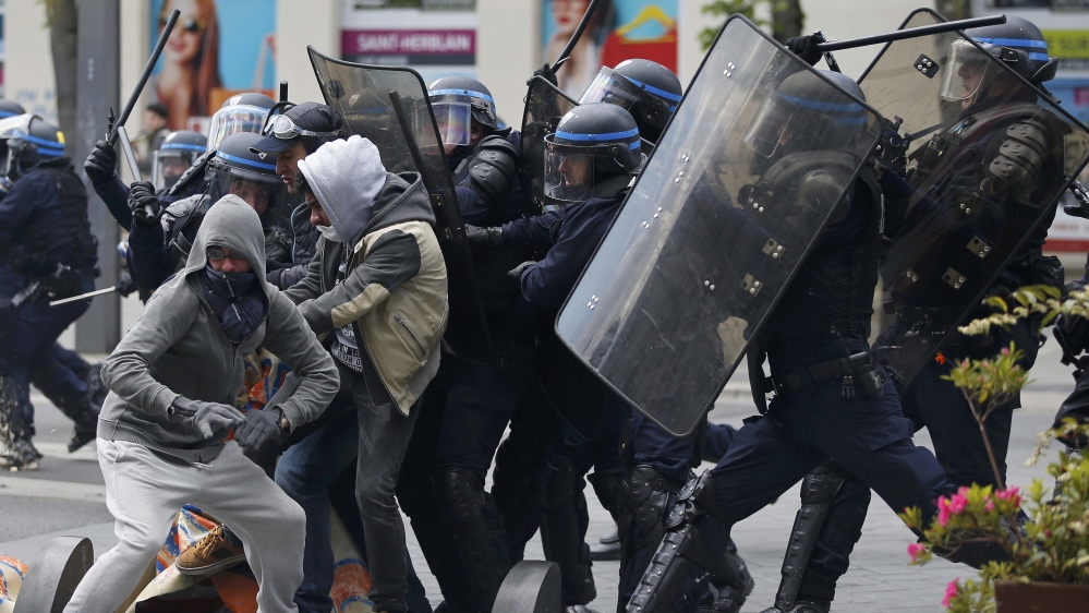 French riot police officers clash with protestors during a demonstration against the French labour law proposal in Nantes