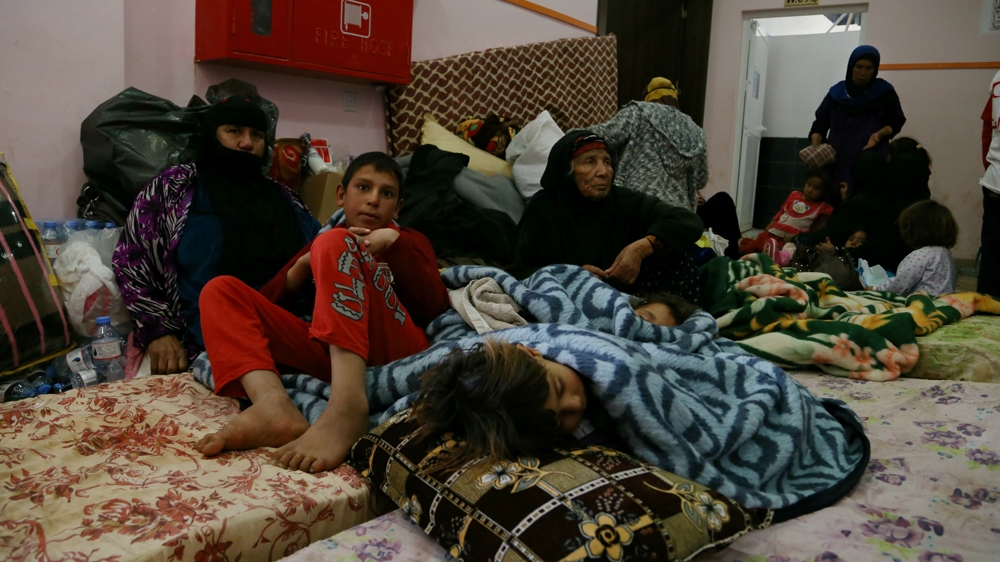 Many of Nineveh's internally displaced people have been crammed into a public building in Makhmour, with no privacy [Mohammed A Salih/Al Jazeera]