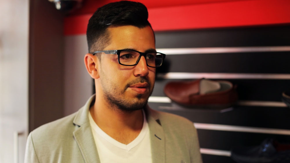 Khalid Yasin, 25, is unable to legally get married, have a phone line installed, or register his business in his name [Abed al-Qaisi/Al Jazeera]