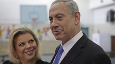 Israeli Prime Minister Benjamin Netanyahu stands with his wife Sara [AP]