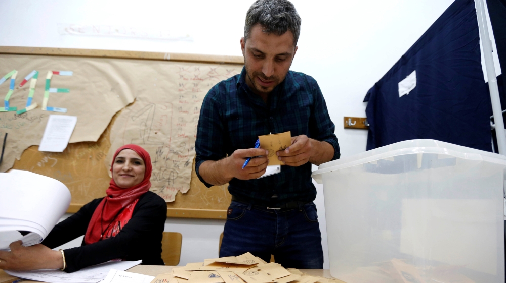 A Lebanese election official counts ballots after their polling station closed during Beirut''s municipal elections