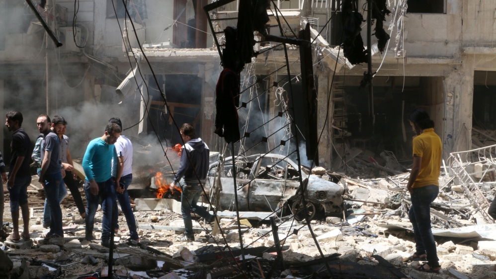 People inspect the damage at a site hit by airstrikes, in the rebel-held area of Aleppo''s Bustan al-Qasr