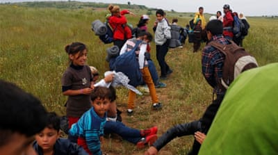 Refugees attempt to cross the Greek-Macedonian border near the village of Evzoni, Greece [Reuters]