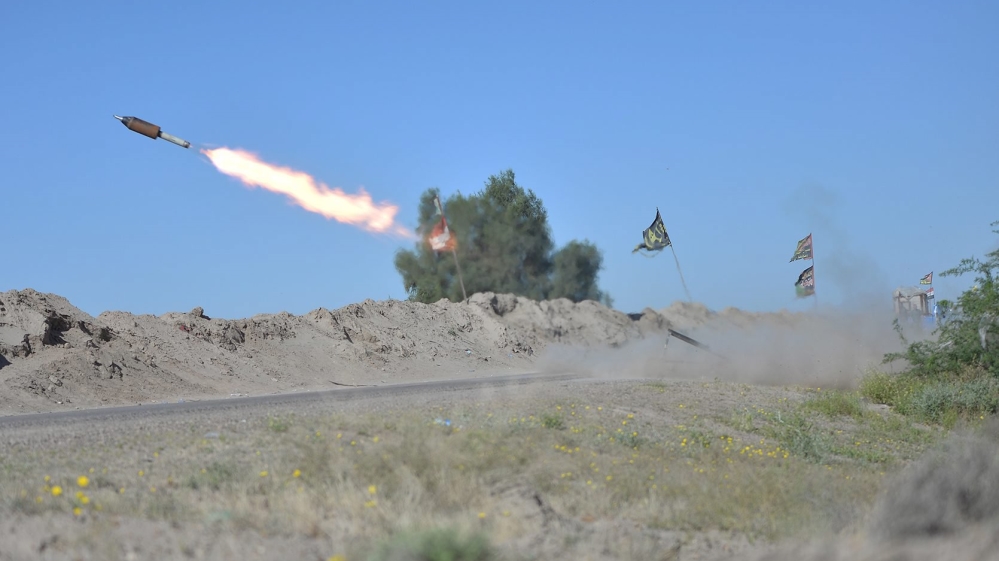 Iraqi fighters fire a rocket toward ISIL positions on the outskirts of Fallujah, west of Baghdad [REUTERS]