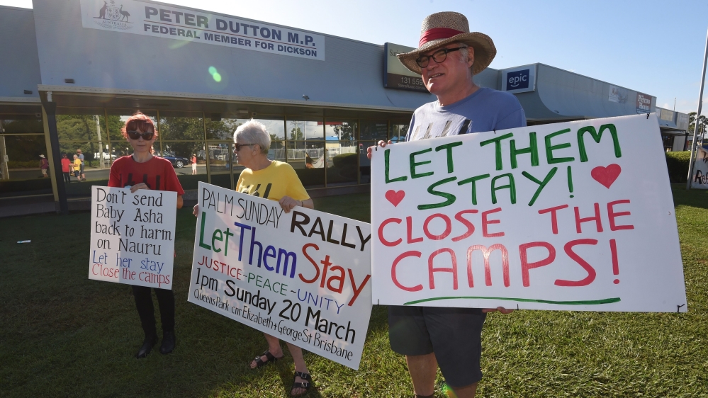 Refugee activists protest outside the electoral office of Australian Immigration Minister Peter Dutton in Brisbane