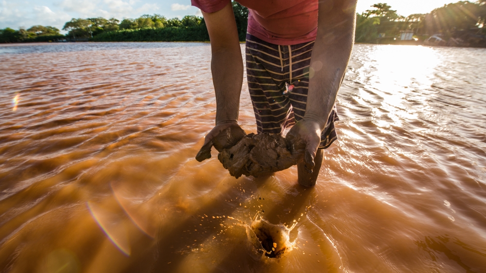 The famous surfing paradise, Regencia, can now only advertise brown surfing waves. Fishermen are not allowed to fish [Fabio Nascimento/Al Jazeera]
