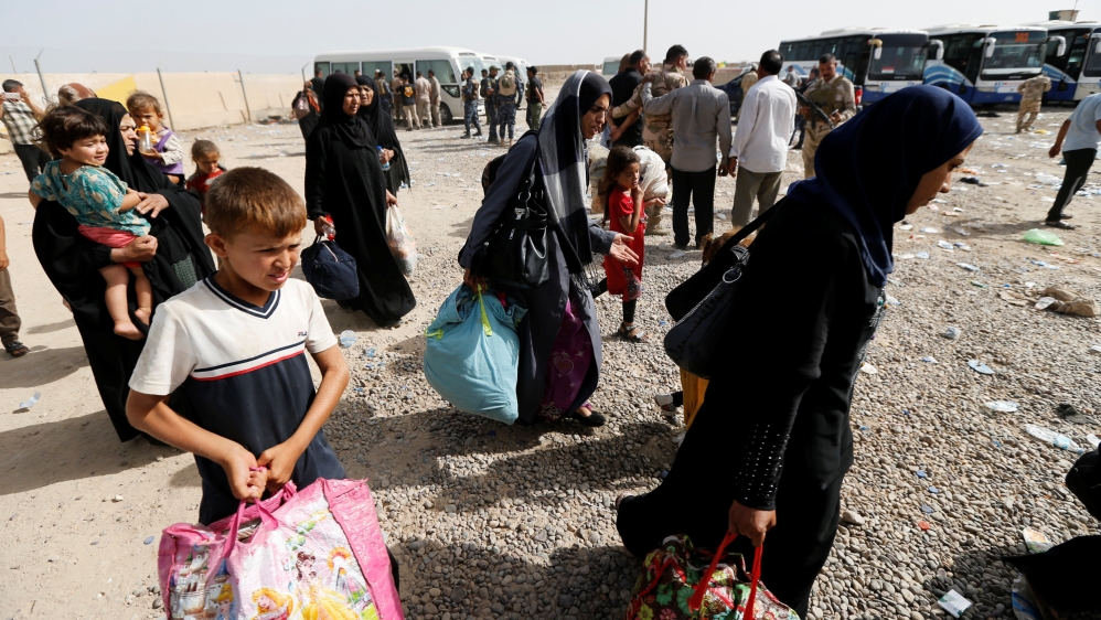 Civilians who fled their homes due to clashes gather at Camp Tariq