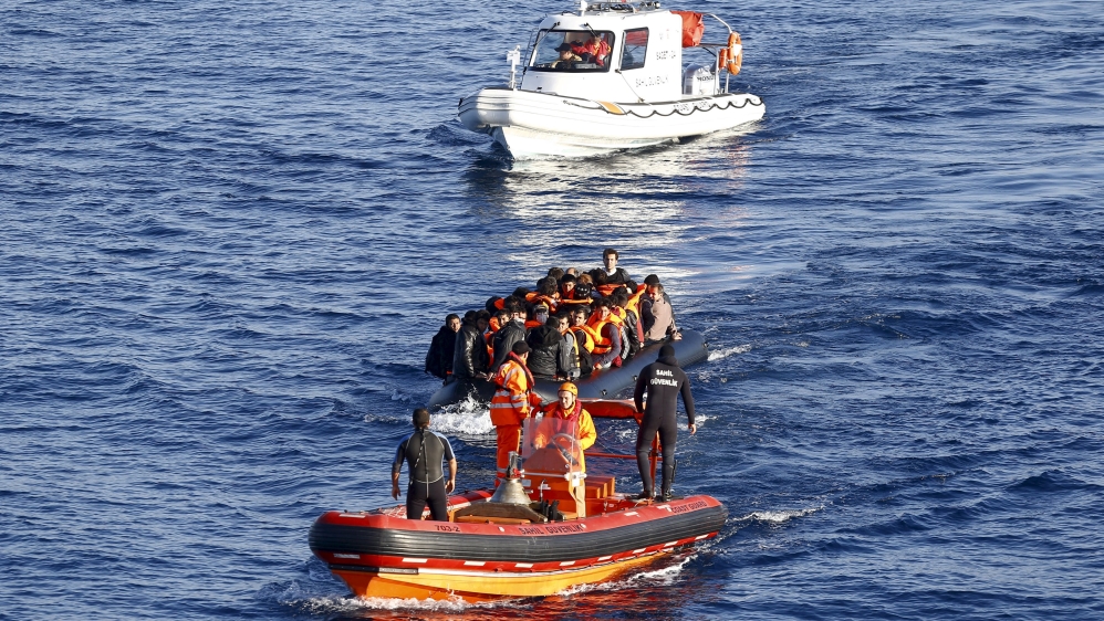 File photo of a Turkish Coast Guard fast rigid-hulled inflatable boat tows a dinghy filled with refugees and migrants in the Turkish territorial waters of the North Aegean Sea