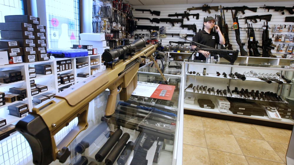 Sniper rifles sit on display for sale at the "Ready Gunner" gun store