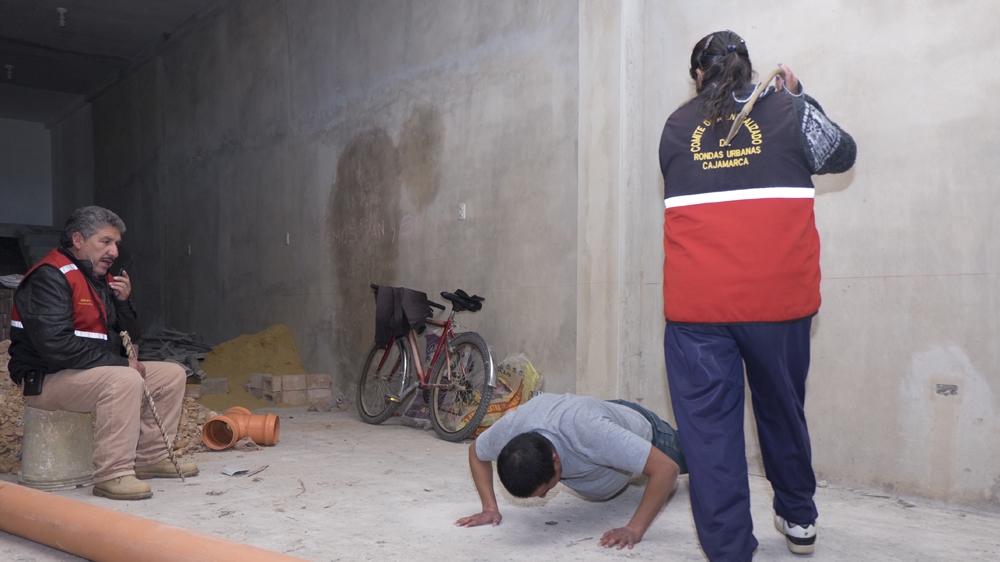 Rondera Maria Teresa del Castillo Peregrino whips a young man during interrogations [Eline van Nes/Al Jazeera] 