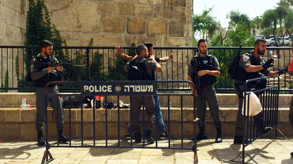 Israeli soldiers frisking Palestinian teen