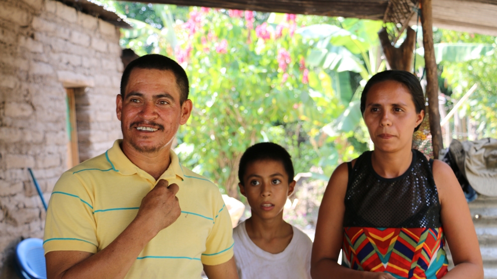 Hernandez at his Los Almendros home with his wife Marie Elise and their oldest son Gustavo [Arwa Aburawa/Al Jazeera]