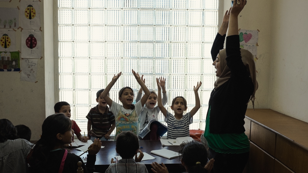 Some residents volunteer and take turns teaching children, as there are no formal classes in the camps [Nick Paleologos/SOOC/Al Jazeera]
