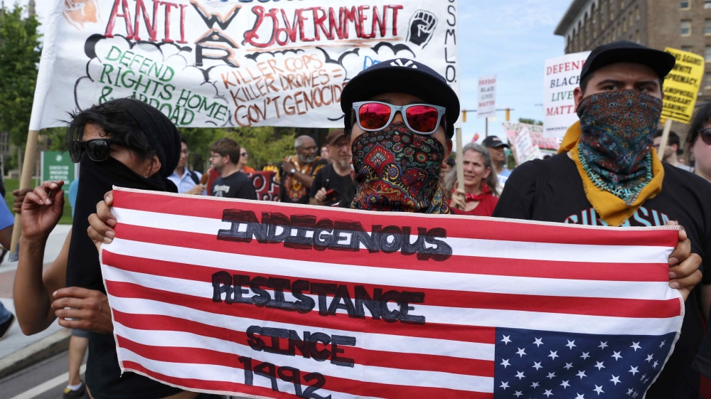 Demonstrators join in a march by various groups, including "Black Lives Matter" and "Shut Down Trump and the RNC" ahead of the Republican National Convention in Cleveland