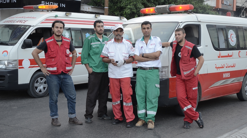 Filmmaker Mohamed Jabaly, left, and the Gaza ambulance crew [Al Jazeera]