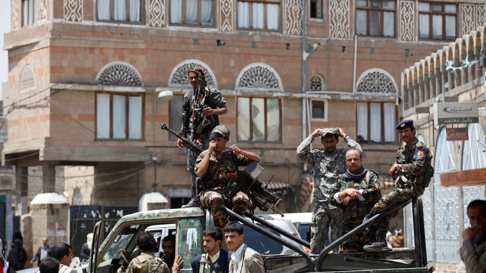 Soldiers stand on the back of a police truck outside Yemen''s parliament during a session held by the parliament for the first time since a civil war began almost two years ago in Sanaa, Yemen