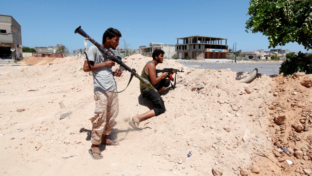 Libyan forces take up position during a battle with Islamic State fighters in Sirte