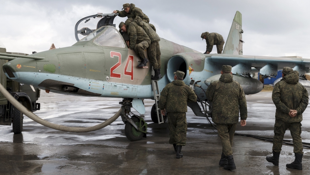 Support personnel prepare Russian Su-25 at Hmeymim airbase
