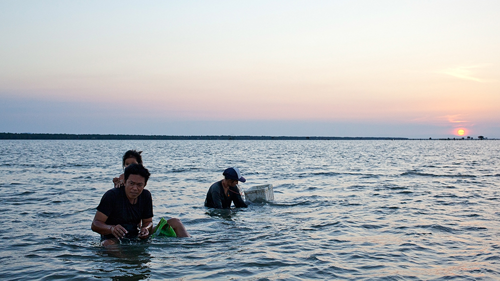 Local villagers in Kanchanadit district in southern Thailand catch crabs a few metres offshore. Onshore, mangroves cover the coastline [Antolin Avezuela Aristu/Al Jazeera]
