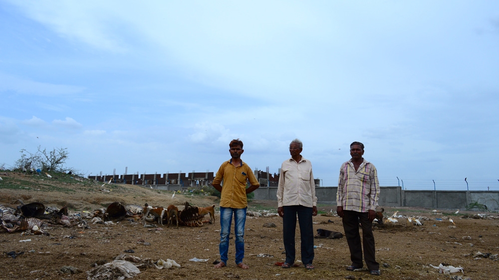 Kishore Solanki, Valjibhai Madhvi, and Rajesh Solanki in Jam Kandorna's skinning field. Generations ago, this was a remote wasteland. As the village has grown, this space has come under increasing pressure [Maya Prabhu/Al Jazeera]