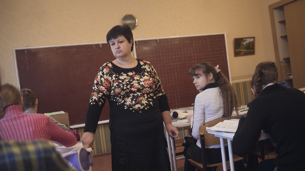 Alla teaches maths at School No 58. When we visited her in November 2015, she had gone many months without pay, even though she had worked throughout the war [Kyrre Lien/Al Jazeera] 