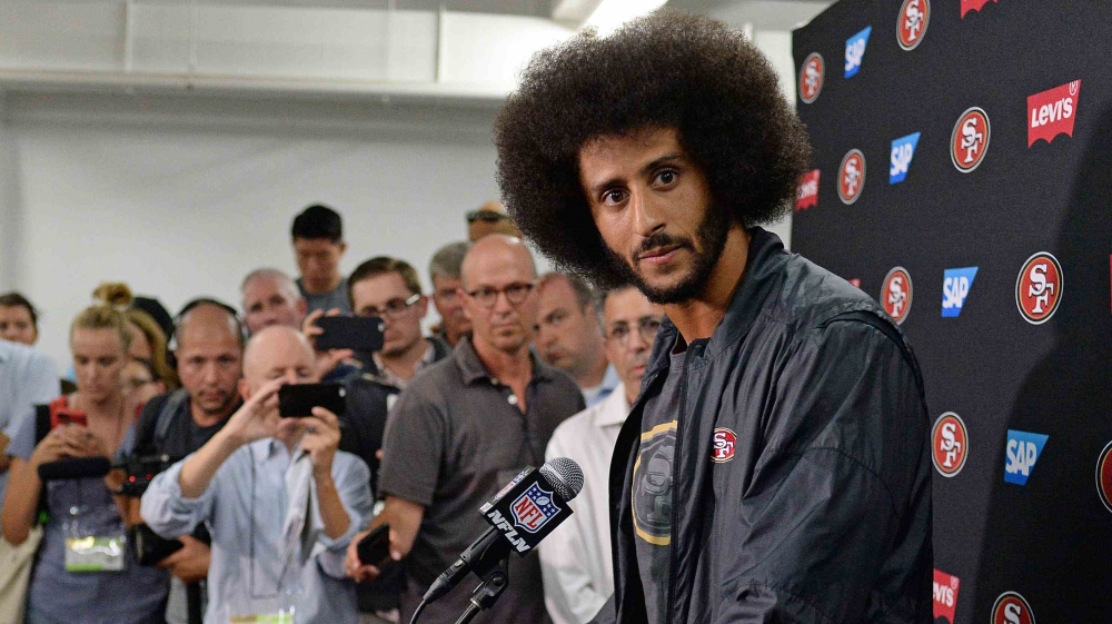  Kaepernick, seen here speaking to the press, protested against police brutality [File: Jake Roth/USA TODAY Sports]