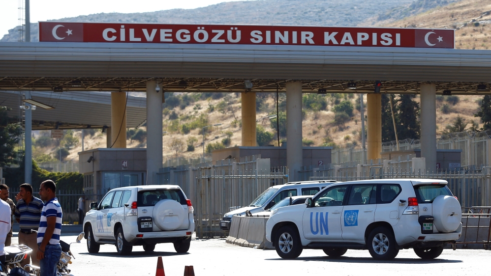 U.N. vehicles enter Syria from Turkey at Cilvegozu border gate, located opposite the Syrian commercial crossing point Bab al-Hawa in Reyhanli