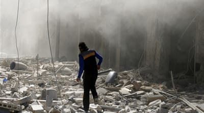 A man walks on the rubble of damaged buildings after an airstrike on the rebel held al-Qaterji neighbourhood of Aleppo [Abdalrhman Ismail/Reuters]