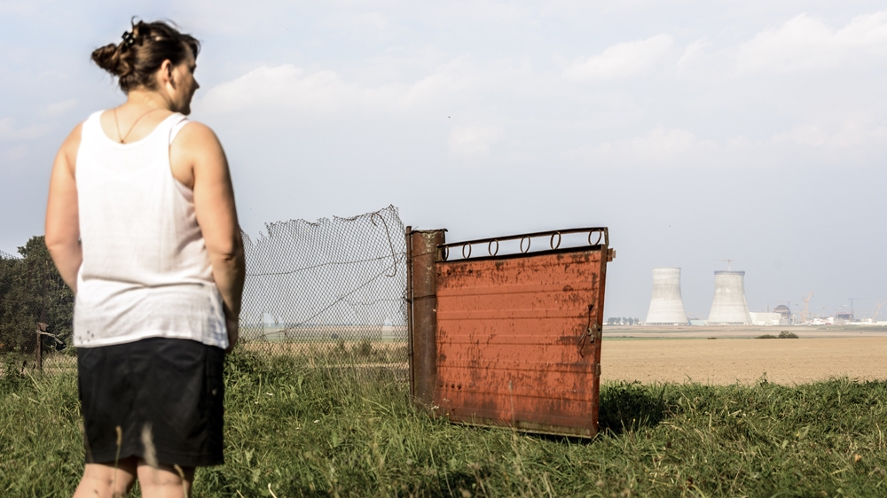 Theresa looks out across the fields towards the nuclear power plant under construction - 'Before it used to be all forest' [ Benas Gerdziunas /Al Jazeera] 