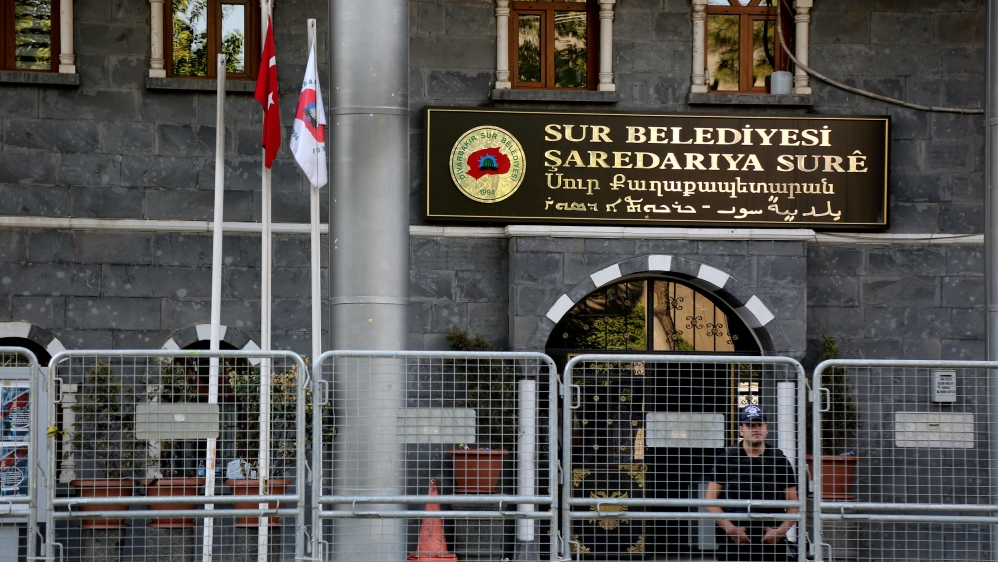 A riot police officer stands guard in front of Sur municipality office, following the removal of the local mayor from office after he was deemed to support Kurdish militants, in Diyarbakir