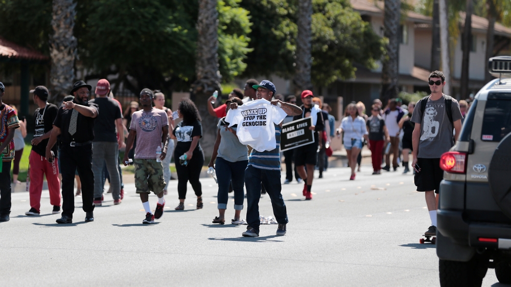 Protesters march at Mollison in El Cajon to protest the fatal shooting of an unarmed black man Tuesday by police in El Cajon