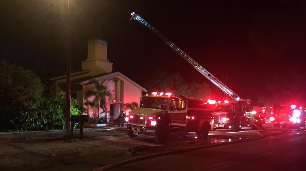 Emergency personnel are seen at the Islamic Center of Fort Pierce which was set on fire, in Fort Pierce