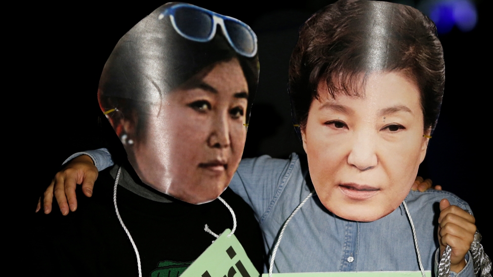 Protesters wearing cut-out of South Korean President Park Geun-hye