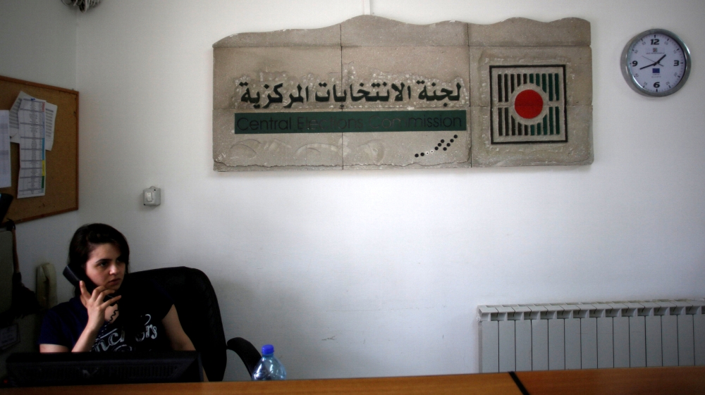 Palestinian employee speaks on the phone in the office of the Central Elections Commission in the West Bank town of El Bireh