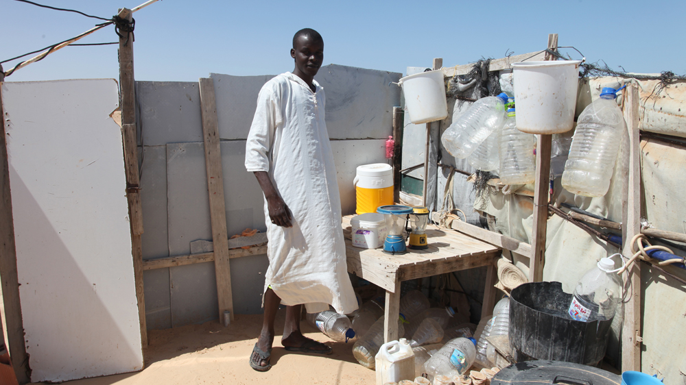 'Since I fell ill, I've just begged for food from the Libyans passing by on the road,' says Ali Ahmed Ali [Thessa Lageman/Al Jazeera] 