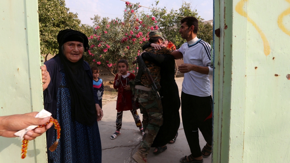 A Kurdish Peshmerga fighter hugs his sister after recapturing the Fadiliya village from Islamic state militants, in Nawaran, north of Mosul