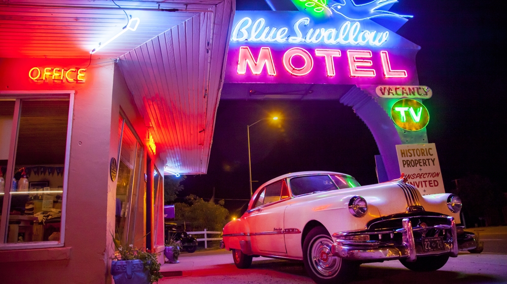  Neon signs illuminate the entrance to the Blue Swallow Motel in Tucumcari. The Blue Swallow was built in 1939 and has since become a landmark along Route 66 [Gabriela Campos/Al Jazeera] 
