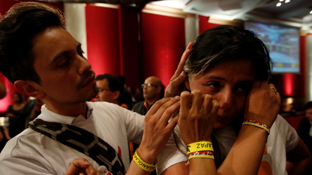 A supporter of "Si" vote cries after the nation voted "NO" in a referendum on a peace deal between the government and FARC rebels at Bolivar Square in Bogota