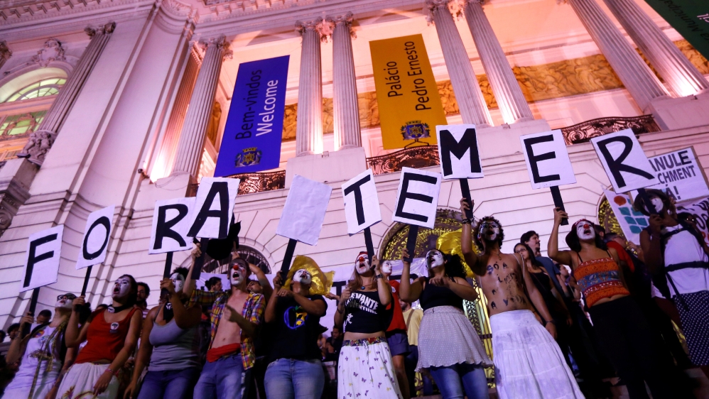 People holding placards against Brazil''s President Michel Temer,
