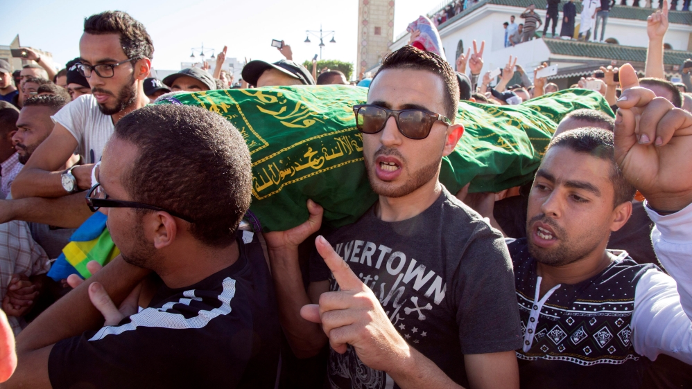 Mourners carry the coffin of fishmonger Mouhcine Fikri who was crushed to death inside a rubbish truck as he tried to retrieve fish confiscated by police in the northern town of Al-Hoceima