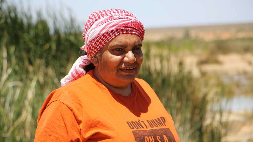 Regina McKenzie is protesting against the proposal to establish a nuclear waste site on sacred indigenous grounds [Jarni Blakkarly/Al Jazeera]