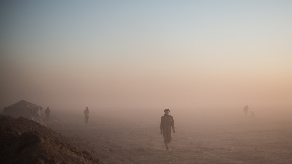 Roads eventually become dry mud and the last 30km to the airport cuts through a virtual moonscape of fine dust that plumes from wheel arches cutting visibility to metres [John Beck/AlJazeera]