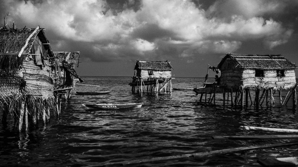 The Badjao are a sea-dwelling tribe, often known as the 'Sea Nomads', who have been floating off the shores of Southeast Asia for centuries. As a nomadic tribe living in stilt huts or boat houses on shallow waters, they make their living from traditional free-diving for fish and pearls. As they belong to no official state and possess no official nationality, they find the move from sea to land a challenge. Because of their nomadic lifestyle, the Badjao are at a disadvantage with no schooling, healthcare or access to government-provided social services. [Guillem Valle/Al Jazeera]