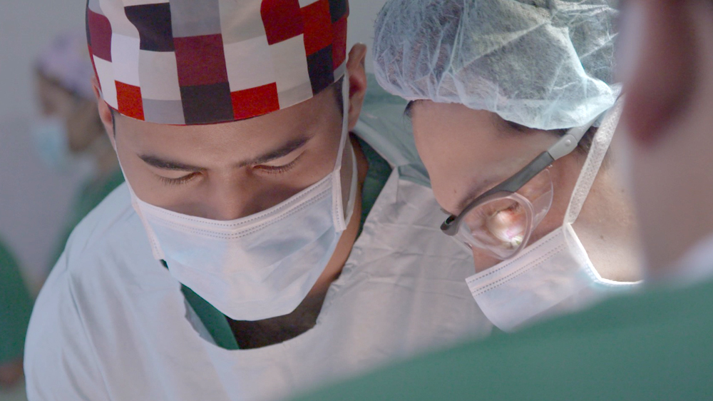 Doctors in Colombia perform surgery. It is typical for young women - even in their teens - to begin saving up large amounts of cash in the hope of affording multiple operations [Al Jazeera]