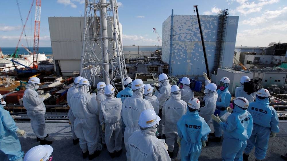 Members of the media receive briefing from Tokyo Electric Power Co. employees at tsunami-crippled Fukushima Daiichi nuclear power plant in Okuma town, Fukushima prefecture