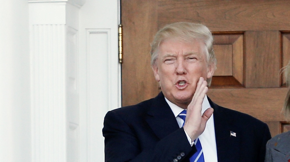 U.S. President-elect Donald Trump stands with Betsy DeVos after their meeting at the main clubhouse at Trump National Golf Club in Bedminster