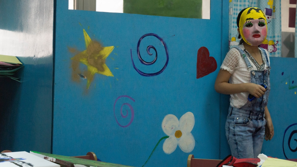 Children in the programme decorated masks to help to express their feelings [Bethan Staton/Al Jazeera]