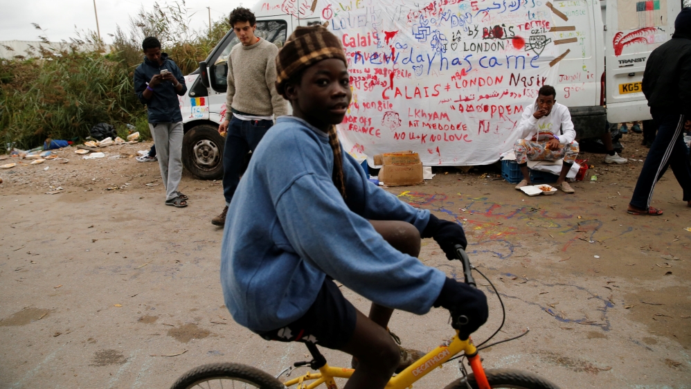 A young boy, one of some 1,500 migrant minors housed temporarily in converted shipping containers since the evacuation last week of the Jungle camp, rides a bicycle in Calais