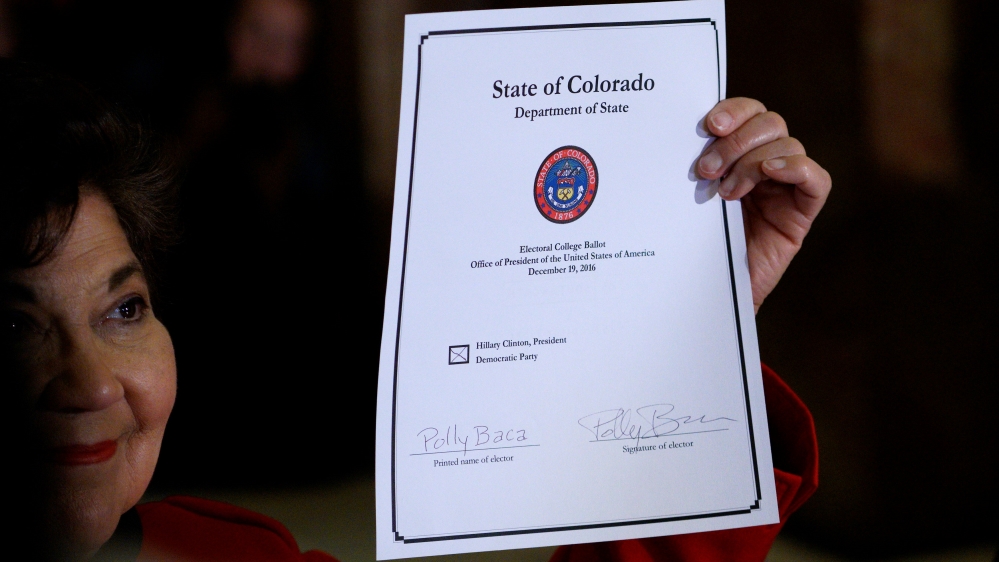 Colorado Electoral College elector Sen. Polly Baca displays her voted ballot after voting at the State Capitol in Denver