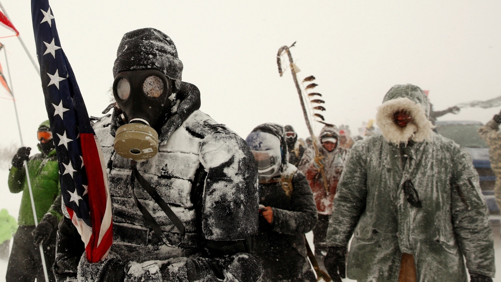 A man takes part in a march with veterans to Backwater Bridge, N Dakota